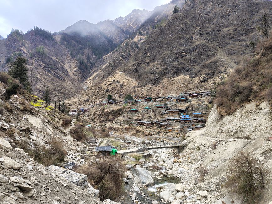 Wooden timber-and-slate houses stacked on a hillside in Osla village