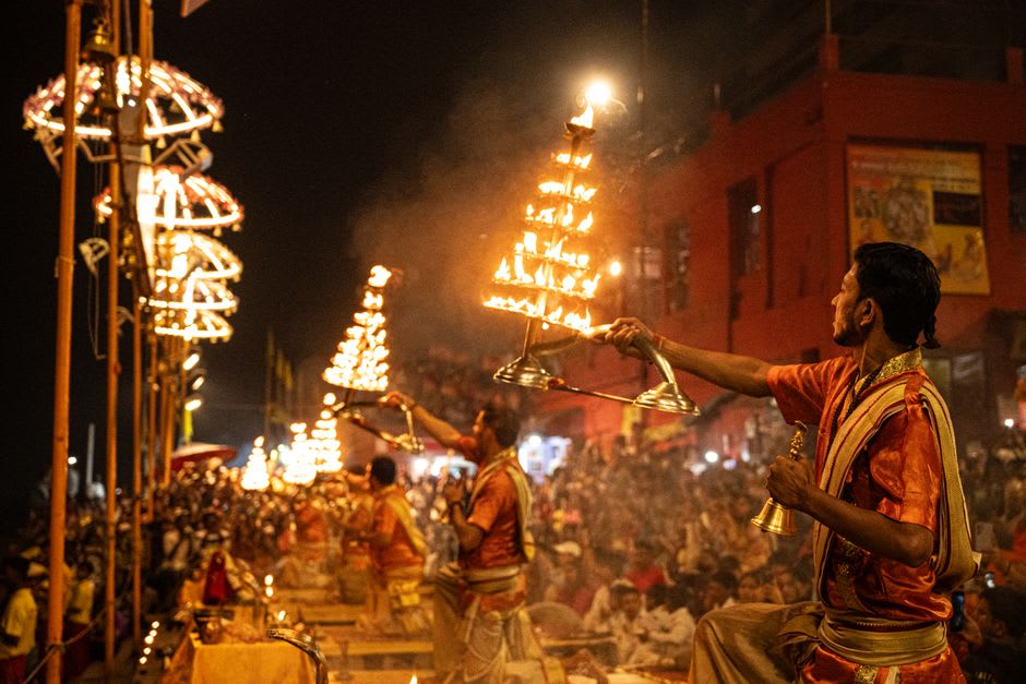 The evening Ganga Aarti ceremony with priests swinging lit brass lamps over the river at Har Ki Pauri