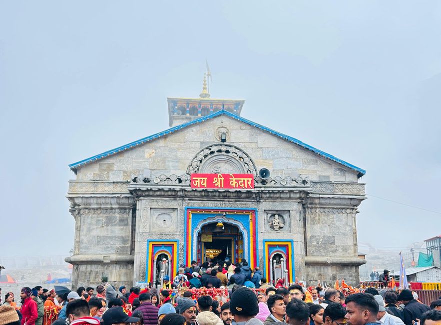 Kedarnath temple's stone structure with the Bhim Shila boulder visible behind it