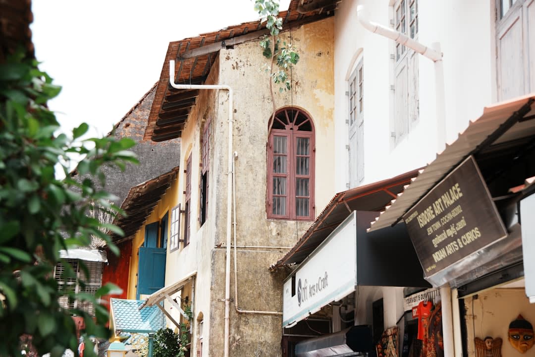 A weathered colonial-era street in Fort Kochi with Portuguese and Dutch architectural details side by side