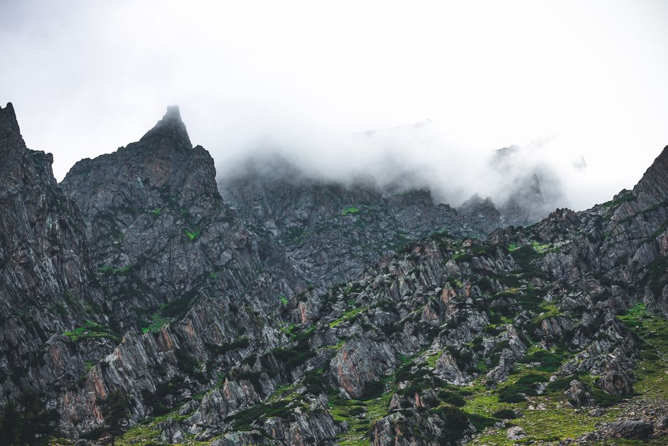 Granite Pillar Rocks emerging through drifting cloud above the shola forest near Kodaikanal