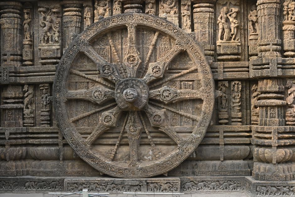 Detailed stone carvings on one of Konark's giant chariot wheels functioning as a sundial