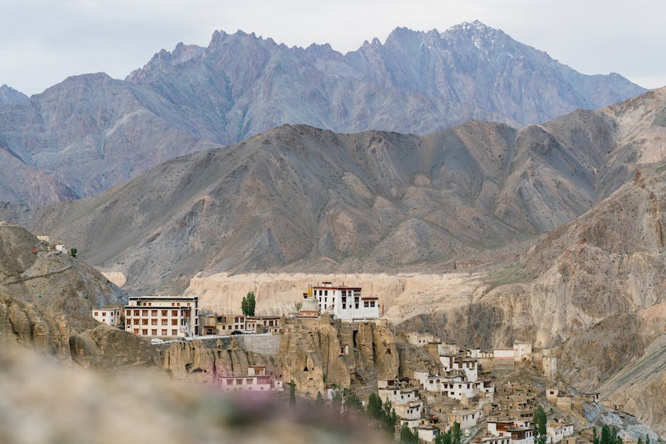 A white-walled Buddhist monastery perched on a barren mountainside in Ladakh