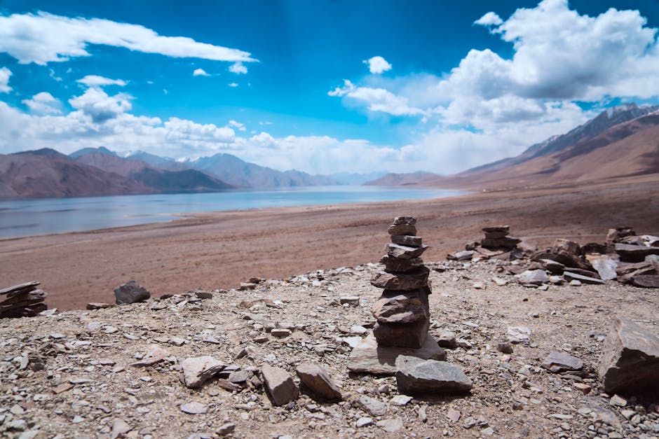 A turquoise high-altitude lake stretching toward barren mountains