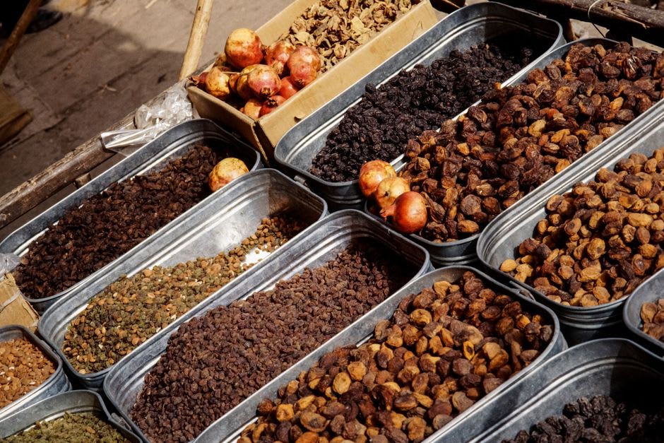 Vendors selling dried apricots and pashmina in Leh's old town bazaar