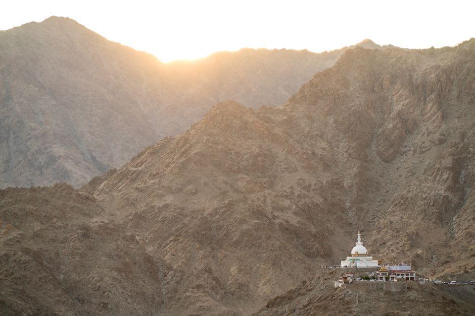 Shanti Stupa's white dome catching early morning light above the Leh valley