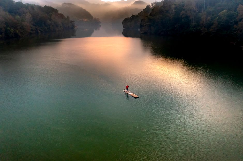 Mist settling over the calm water of Venna Lake at dusk in Mahabaleshwar