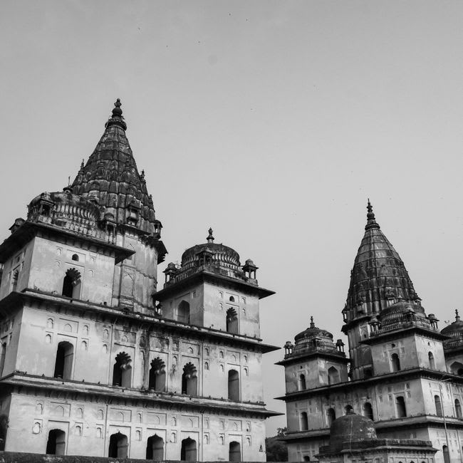 The domed sandstone chhatris of Orchha's Bundela kings lined along the Betwa riverbank