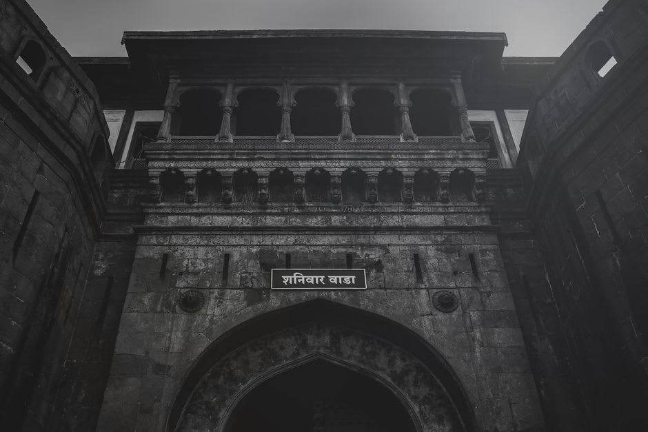 The ruined stone ramparts of Shaniwar Wada fort illuminated at dusk