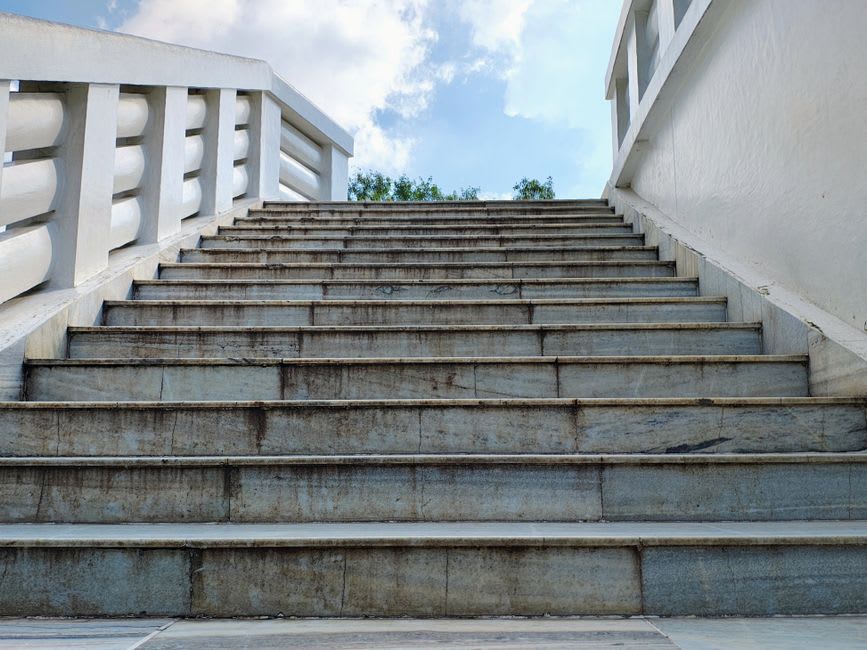The distinctive black marble pathways and maroon-robed visitors at the Osho Ashram campus