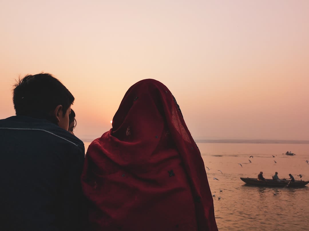 Pilgrims bathing at the stone ghats of Pushkar Lake in early evening light