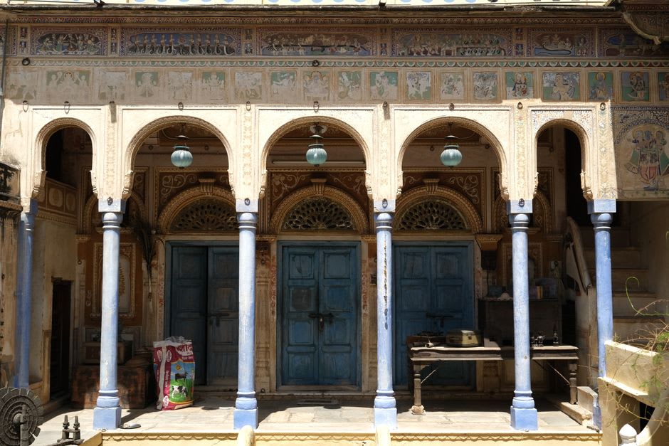 A narrow lane in Mandawa lined with painted haveli facades in faded ochre and blue