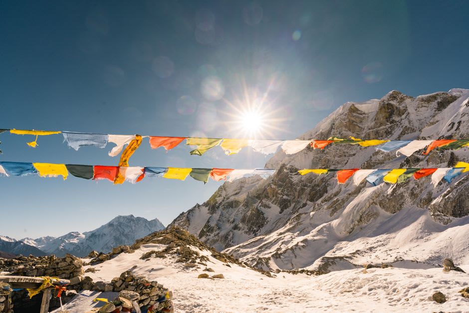 Prayer flags and mountain peaks seen from the ridge above Tawang town
