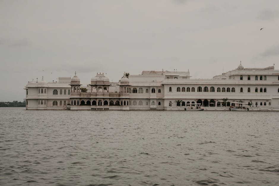 The white marble City Palace of Udaipur rising from the lakefront