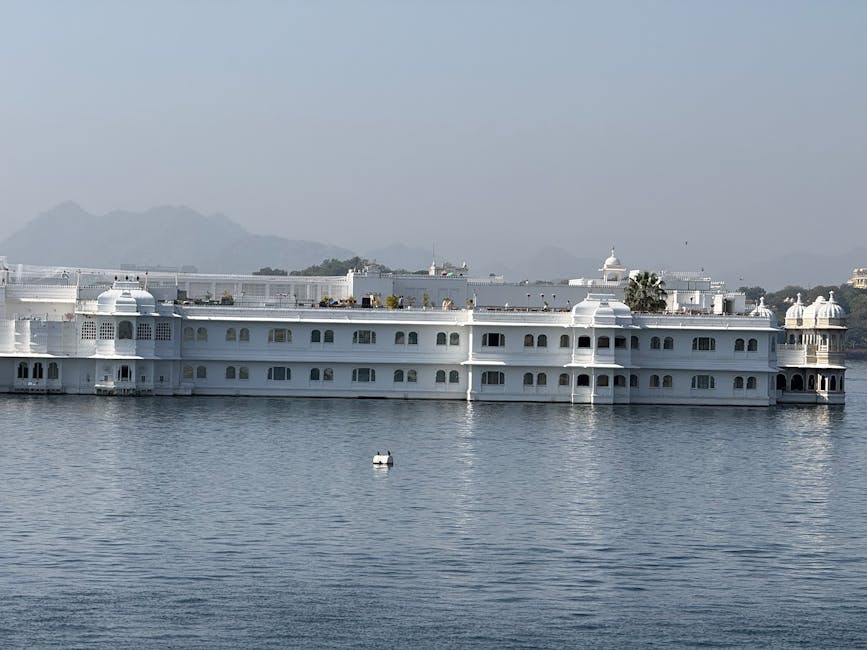 Lake Pichola at sunset with the illuminated palace reflected in the water