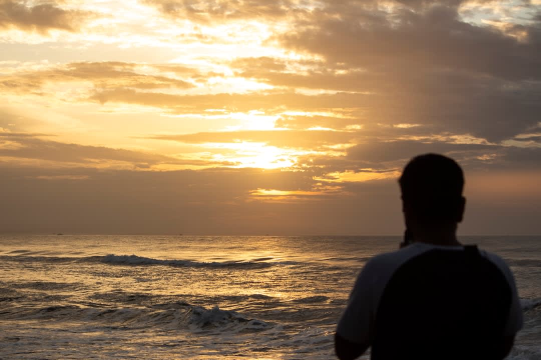 Hindu pilgrims performing rituals at sunrise on Papanasam Beach, Varkala