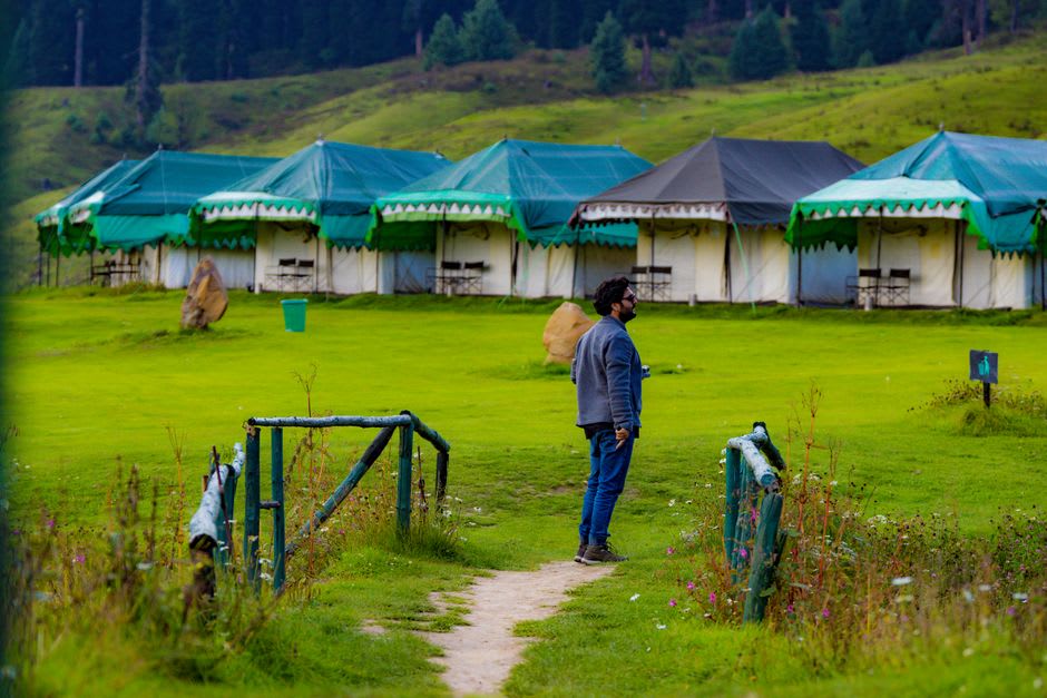 A shepherd family's summer camp set up on the open meadow of Yusmarg