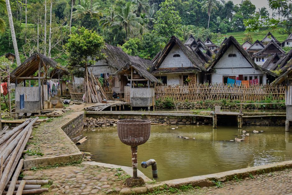 Traditional thatched longhouses along the ceremonial avenue of Tenganan village near Candidasa