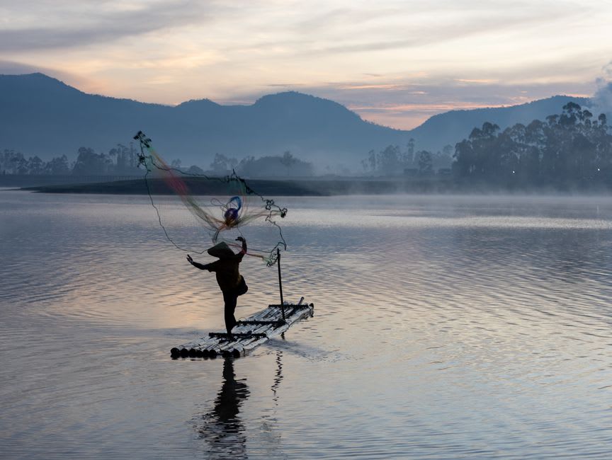Wooden rafts on the still waters of Situ Bagendit lake near Garut