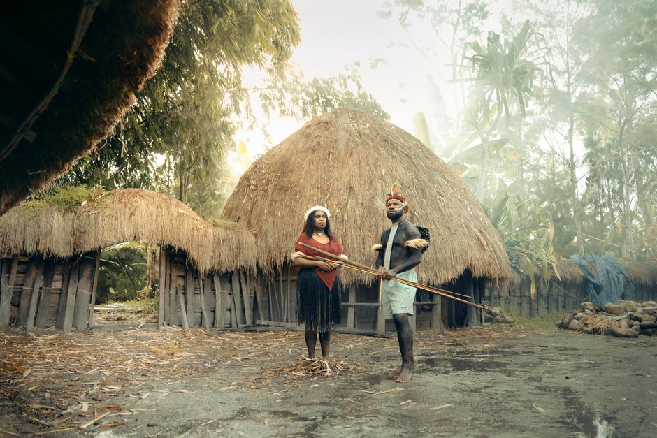 Dani village of thatched honai huts encircled by a wooden fence in the highlands
