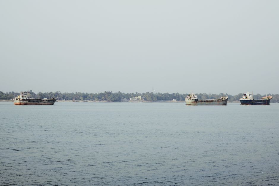 A rusted ship generator vessel sitting inland among houses, a tsunami memorial in Banda Aceh