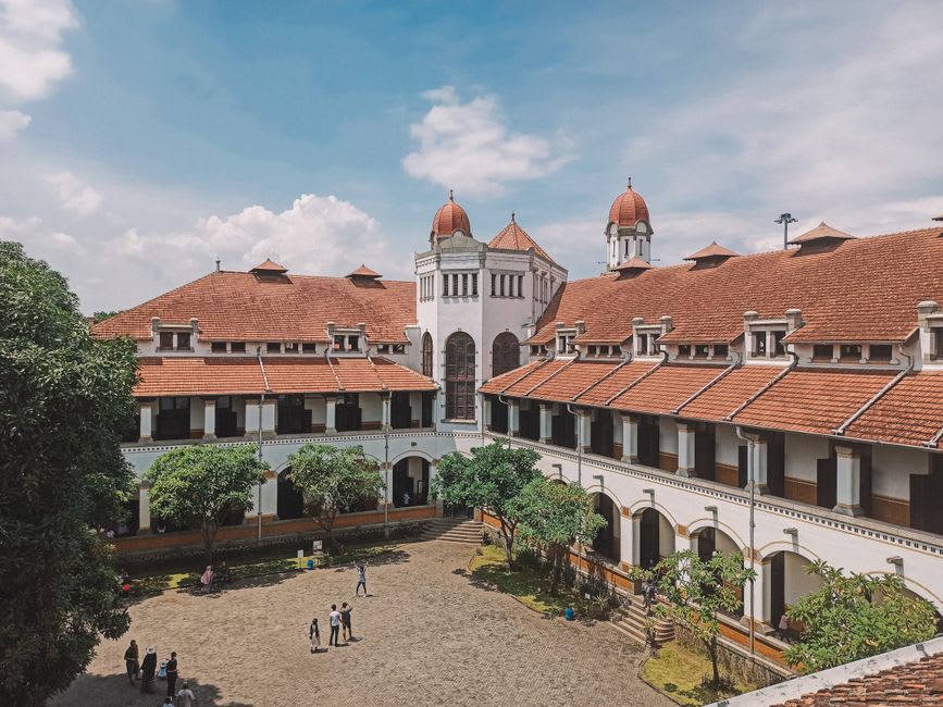 Rows of tall shuttered windows and doors along the corridor of Lawang Sewu in Semarang