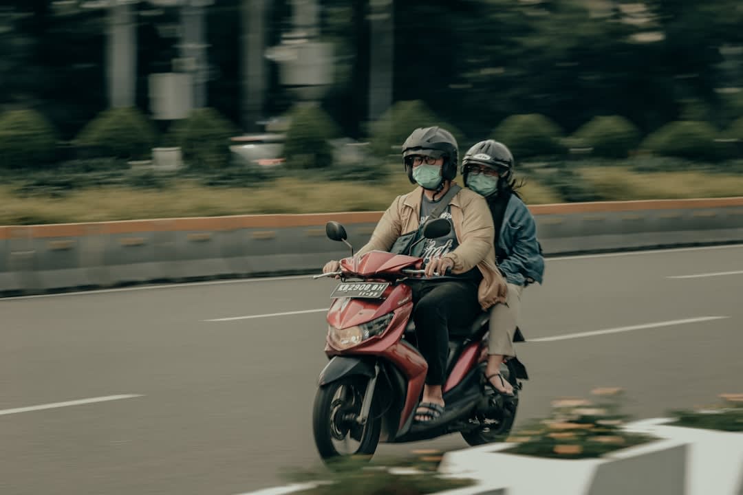 Narrow kampung alley in central Jakarta strung with laundry and motorbikes
