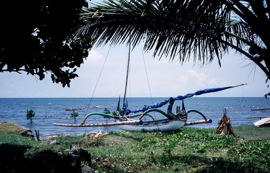 Colorful wooden jukung fishing boats moored in the sheltered bay at Padang Bai