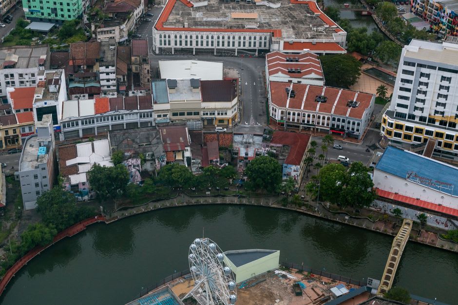 Dutch colonial-era warehouses and shophouses along the Batang Arau riverfront in old Padang