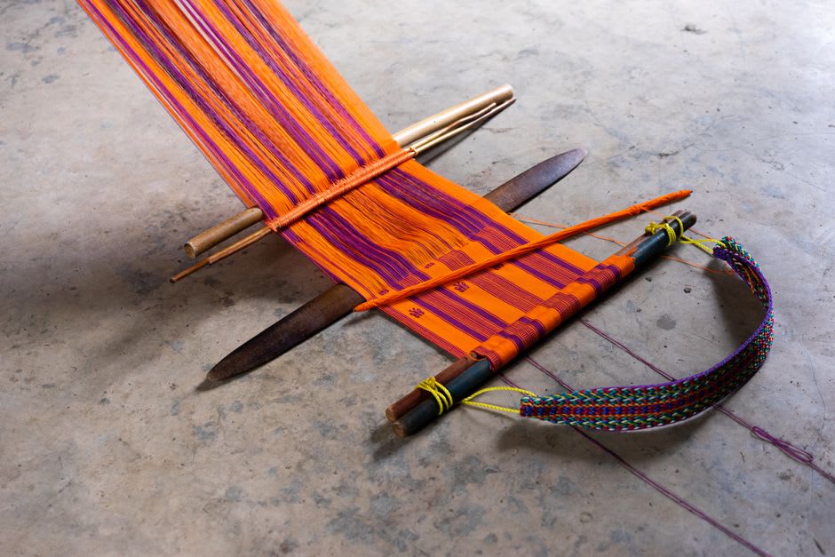 Traditional ikat weaving on a backstrap loom in a Sidemen village workshop