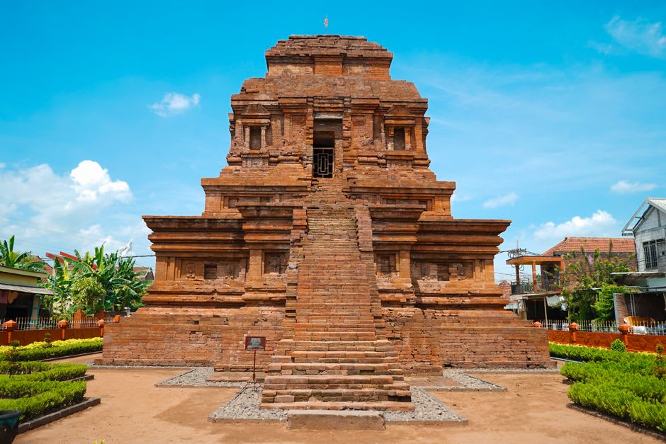 Ancient brick gateway of Candi Bajang Ratu rising above the East Java plain