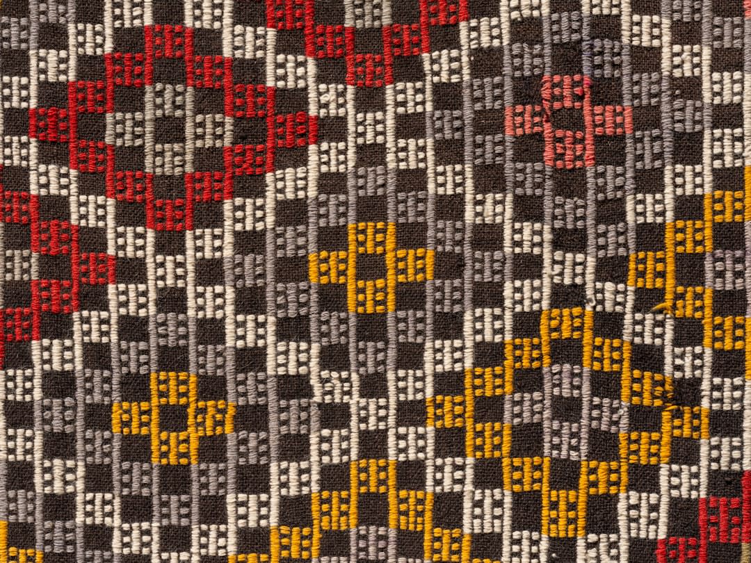 A woven East Sumba ikat cloth with traditional horse and ancestral motifs