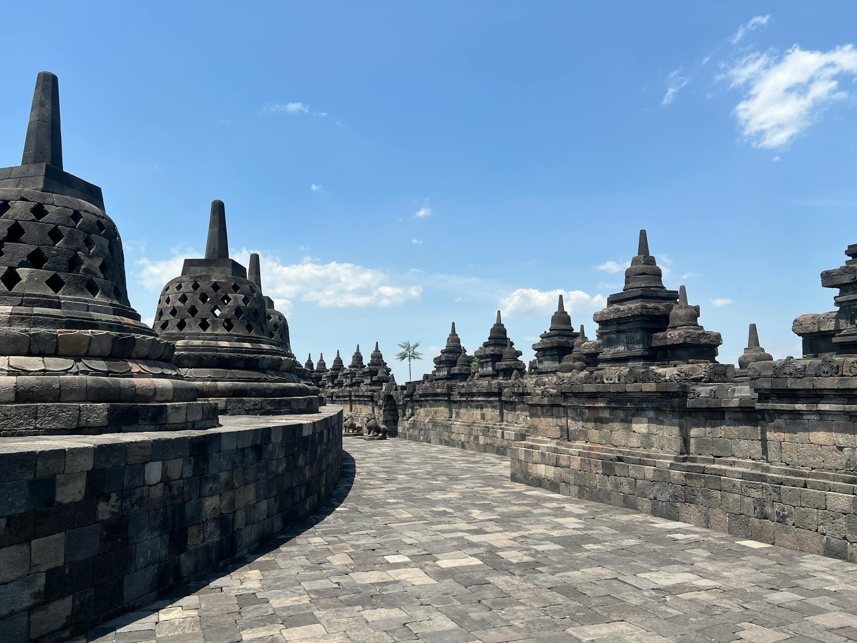 Ancient temple spires rising against a misty Javanese sky