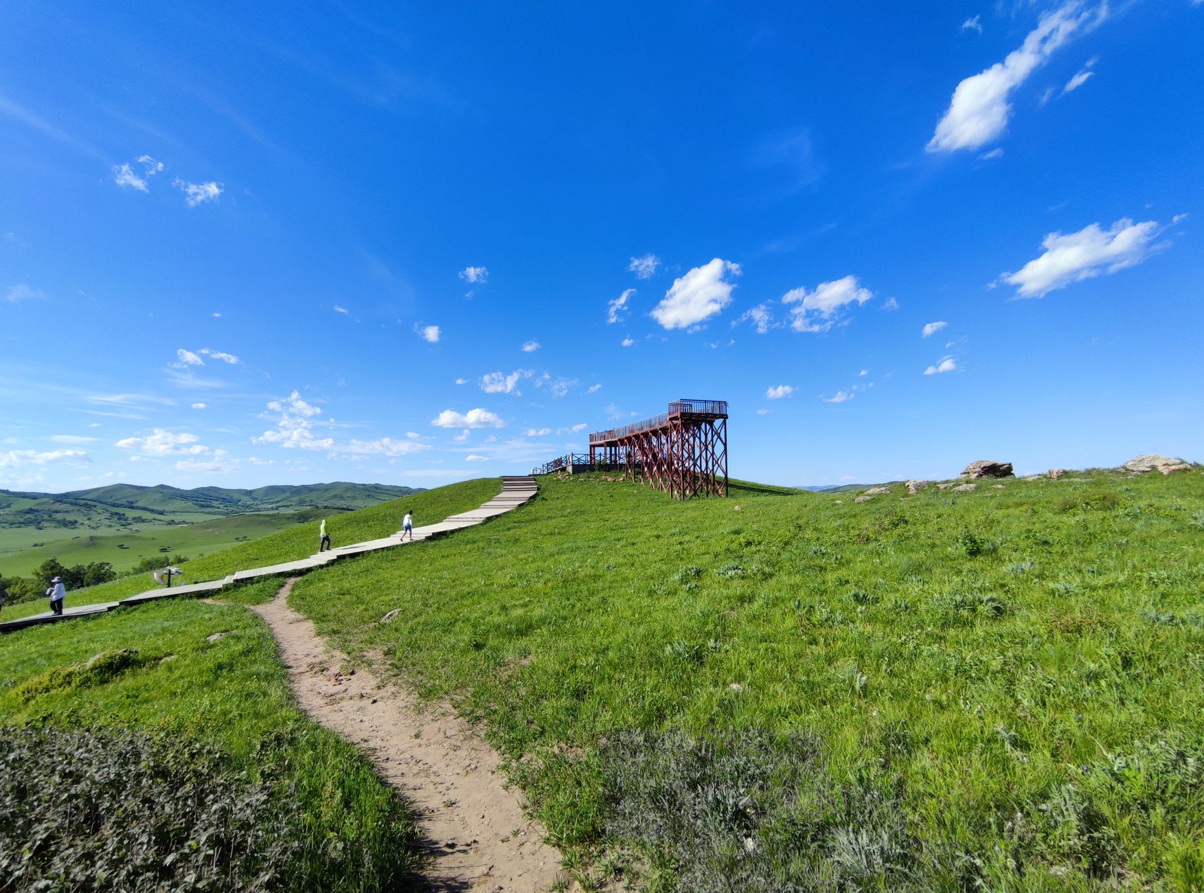 Night sky over Gegentala grassland with the Milky Way visible and a single yurt lit from within on the dark steppe below