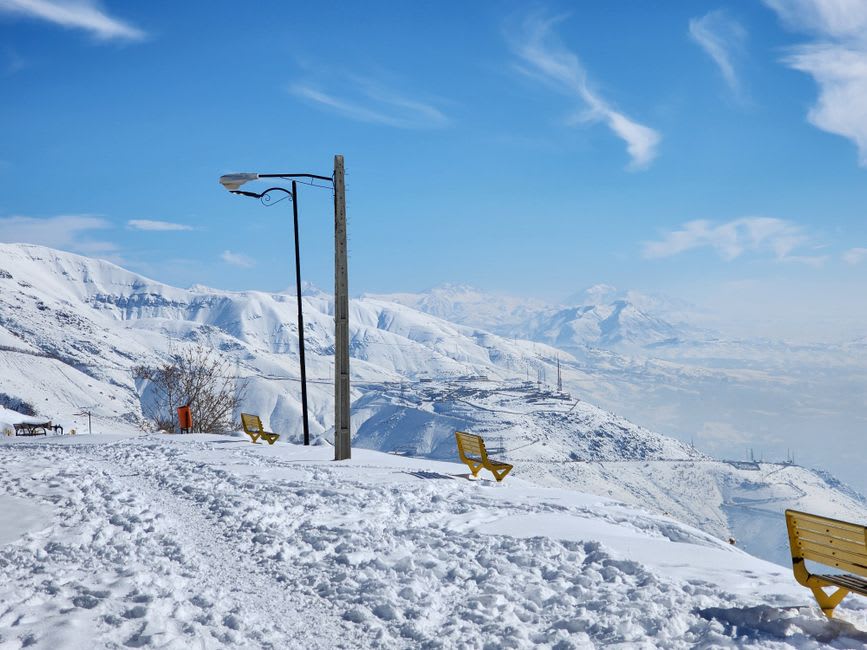 Skier descending a steep, ungroomed powder run above Shemshak village