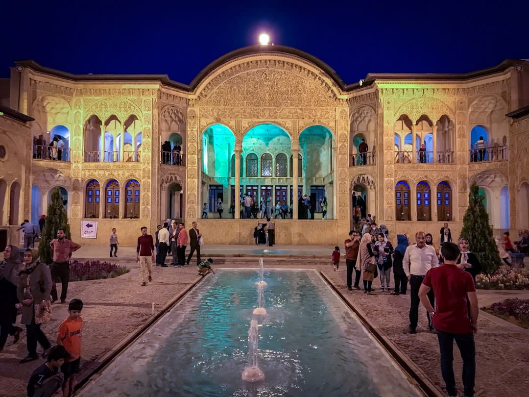 Sunken central courtyard with a rectangular pool and orange trees at Tabatabaei House