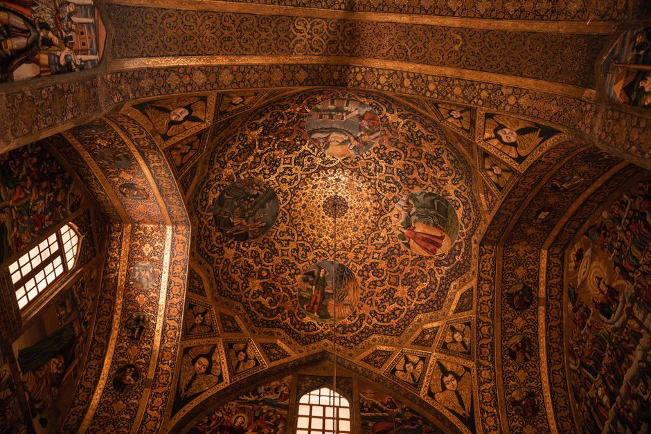 The gilded interior ceiling of Vank Cathedral, painted with a detailed biblical fresco in a European style