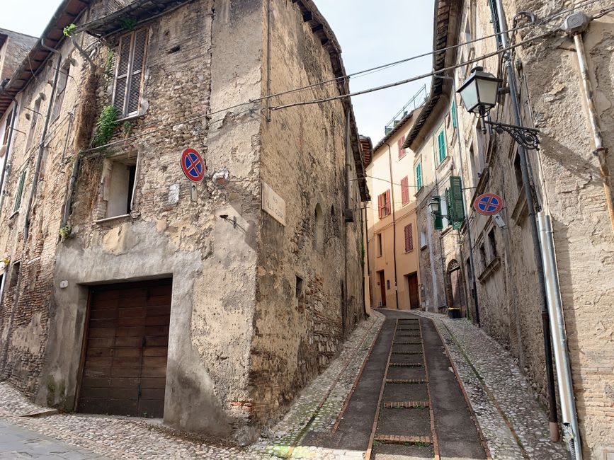 A quiet stone street in Campobasso's old town lined with weathered facades