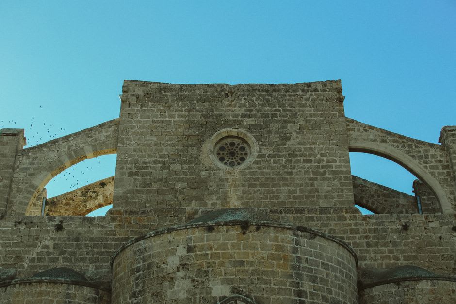 Cefalù's medieval washhouse with stone arches over flowing spring water