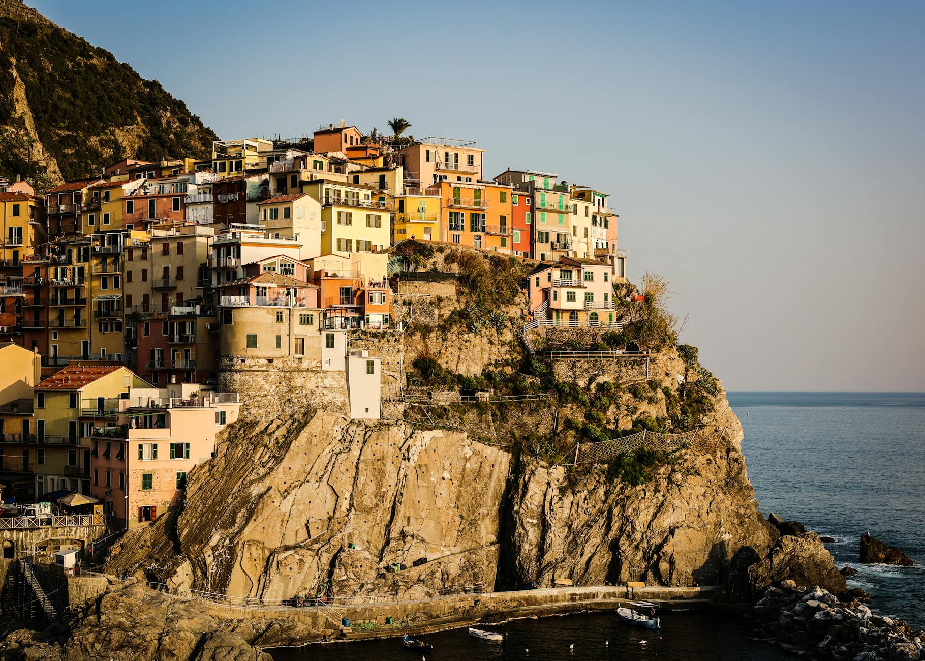 Manarola's houses glowing in warm sunset light against the sea
