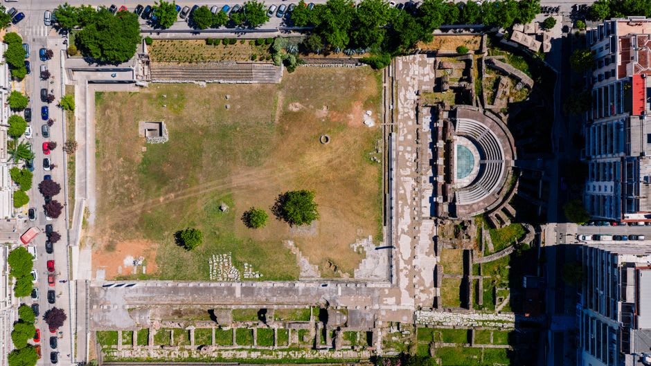 Excavated Roman ruins and column bases in the Aquileia archaeological park