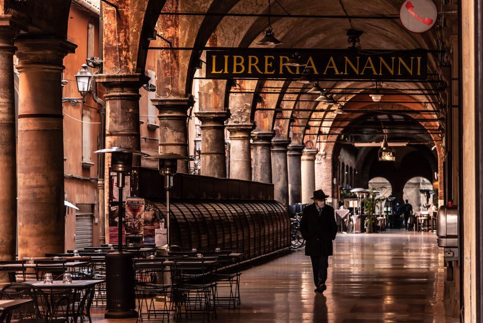 The porticoed arcades and travertine paving of Piazza del Popolo in Ascoli Piceno