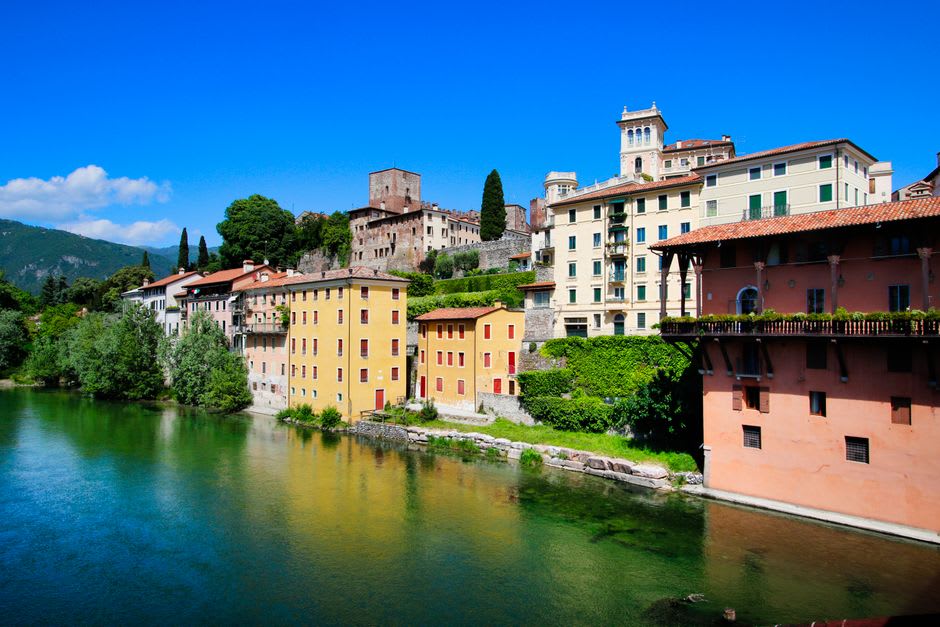 Pastel townhouses and cafés lining a piazza in Bassano del Grappa's old center