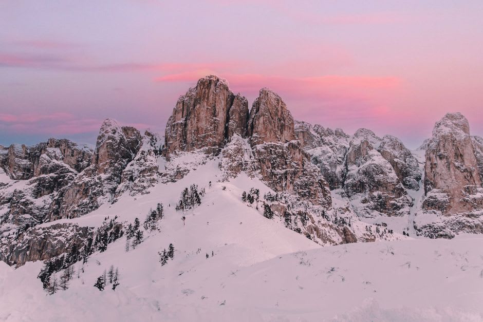The alpenglow enrosadira effect turning the Tofana peaks pink above Cortina d'Ampezzo