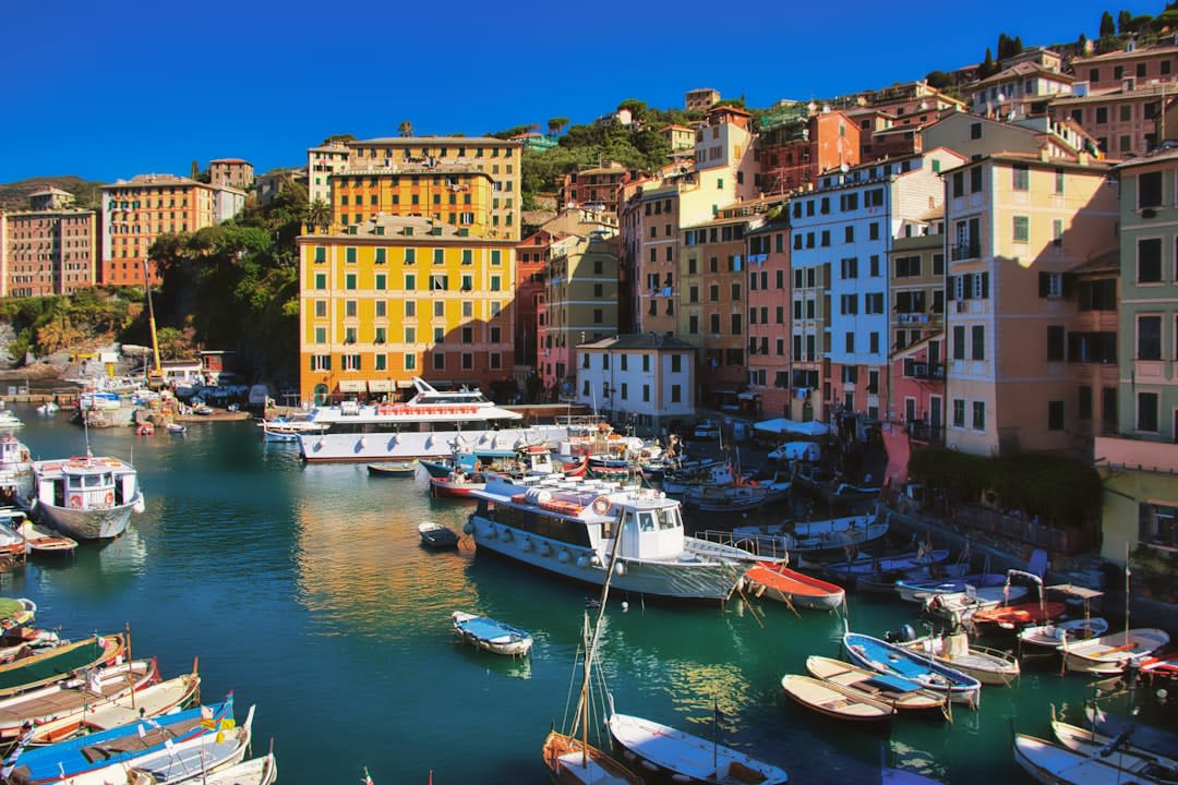 The pastel hillside piazzetta of Porto Cervo overlooking the yacht-filled marina at dusk