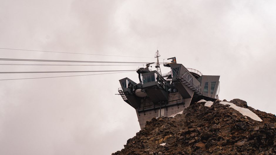The rotating Skyway Monte Bianco cable car ascending toward Punta Helbronner above glaciers and jagged peaks