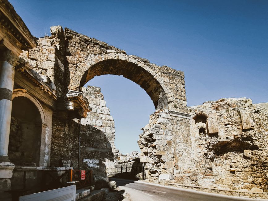 The weathered Roman Arco di Augusto standing at the edge of Fano's old town