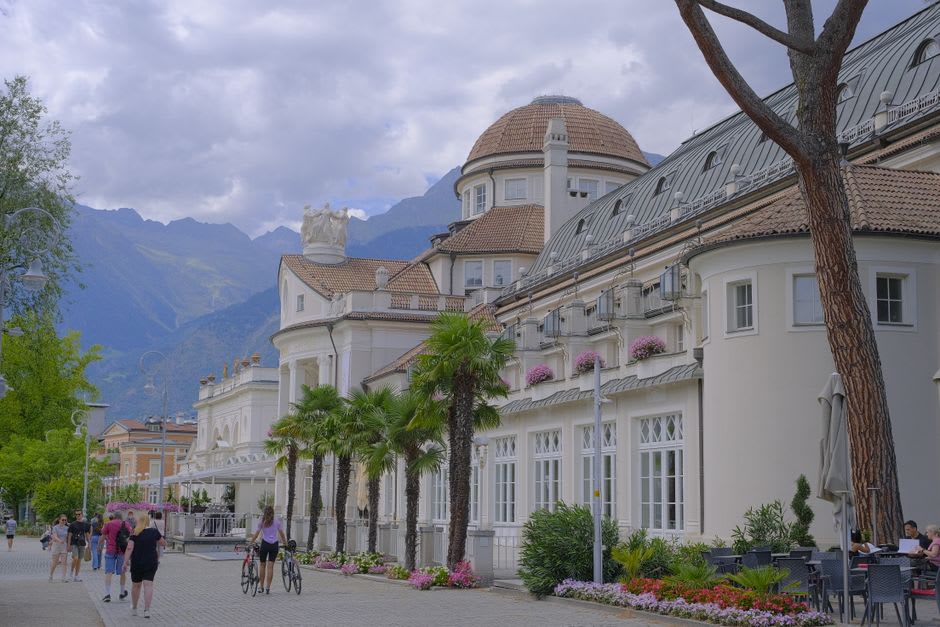 The Passer river promenade in Merano lined with Mediterranean plants and mountain views