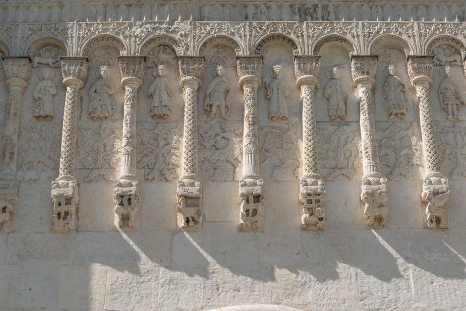 Wiligelmo's carved Genesis reliefs on the Romanesque facade of Modena's cathedral