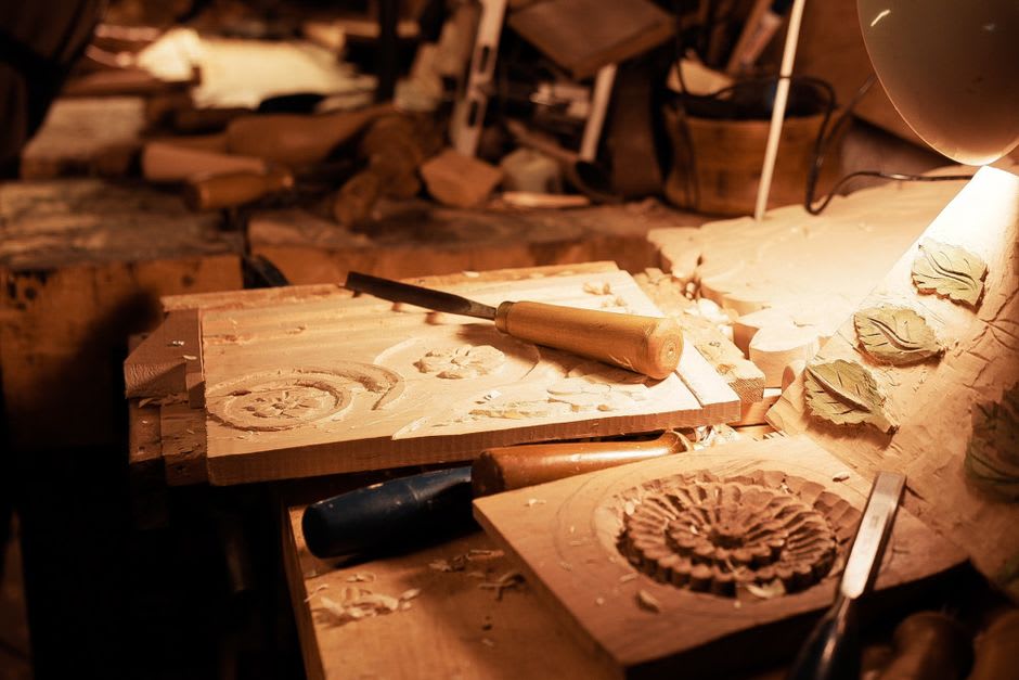 A woodcarver's workshop in Ortisei with carved religious figures in progress